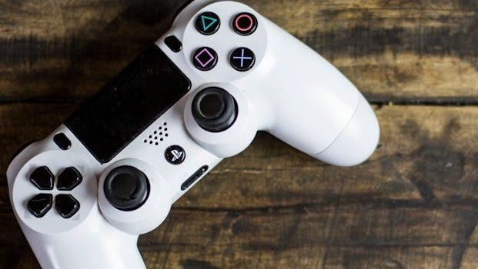 a gaming console on the wooden surface
