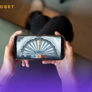 Person playing Roobet Ice Fishing on their phone