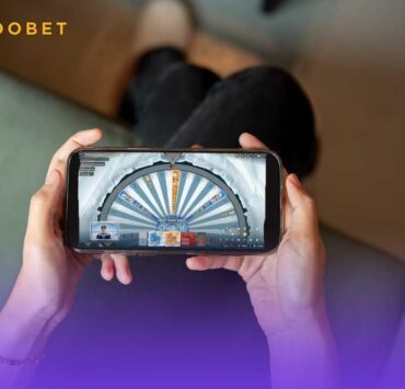 Person playing Roobet Ice Fishing on their phone