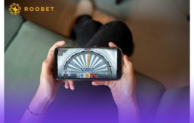 Person playing Roobet Ice Fishing on their phone